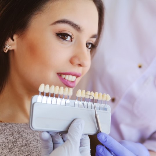 Woman's smile compared with veneers color options