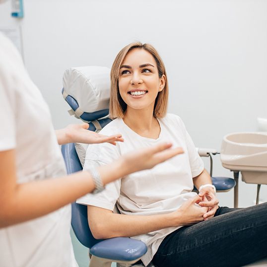 closeup of dentist coloring dental crown