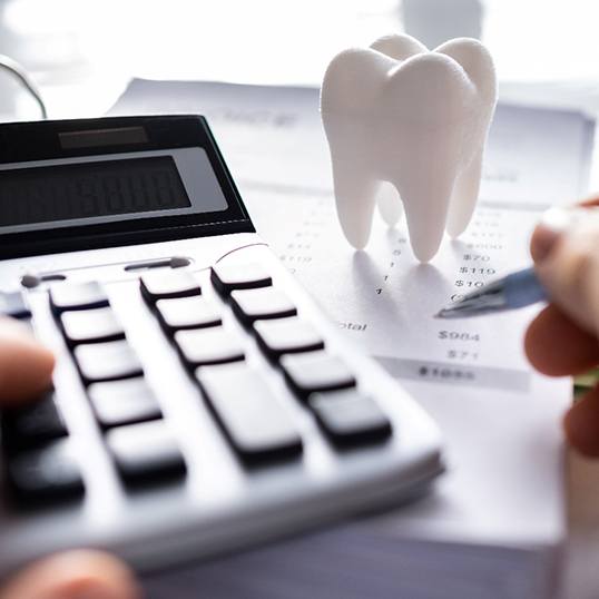 A patient calculating the cost of dental crowns