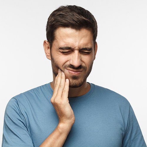 Man wearing pained expression because of a toothache