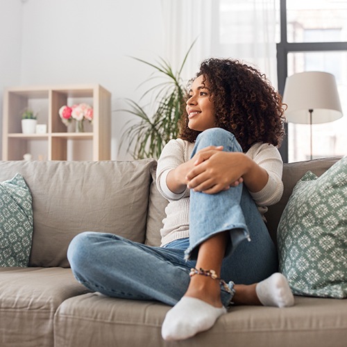 a woman relaxing on a sofa