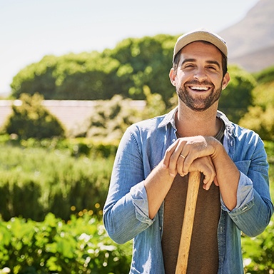 a smiling man gardening