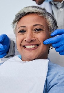 a patient smiling after receiving dental care 