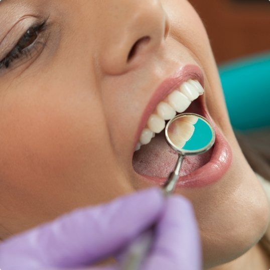 Dentist performing an oral cancer screening