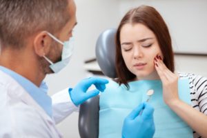 a woman getting her dental emergency treated by her dentist