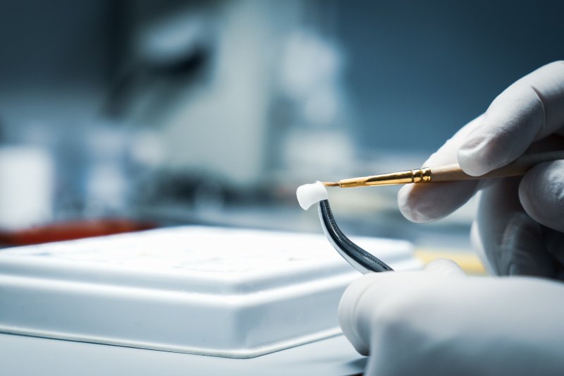 A lab worker making a dental crown